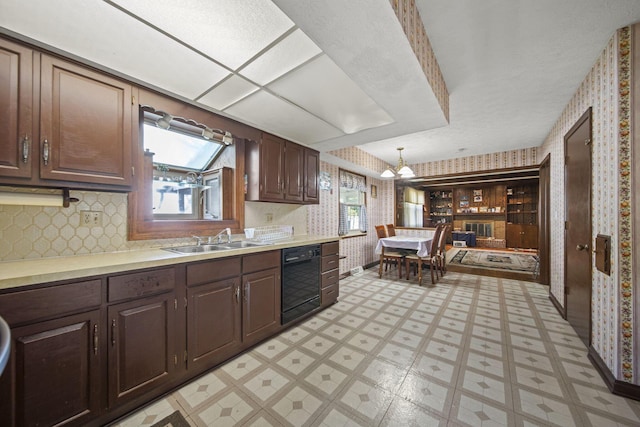 6329 Birkewood St, Columbus, OH 43229 - kitchen with a sink, wallpapered walls, black dishwasher, light countertops, and light floors