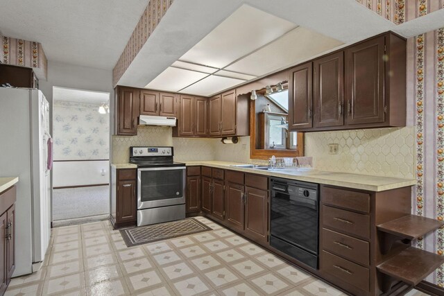 6329 Birkewood St, Columbus, OH 43229 - kitchen featuring stainless steel electric range oven, freestanding refrigerator, under cabinet range hood, dishwasher, and wallpapered walls