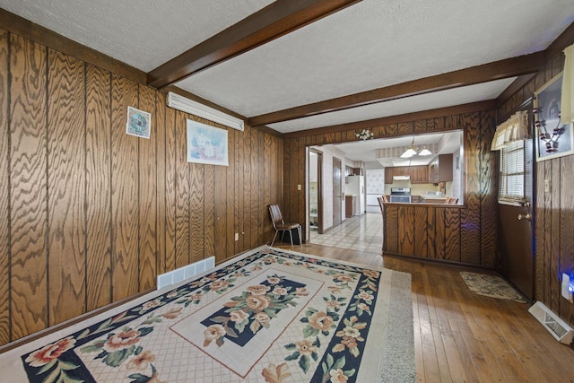 6329 Birkewood St, Columbus, OH 43229 - foyer with wood walls, a textured ceiling, wood-type flooring, and beamed ceiling