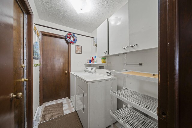6329 Birkewood St, Columbus, OH 43229 - laundry room featuring cabinet space, independent washer and dryer, a textured ceiling, and light floors