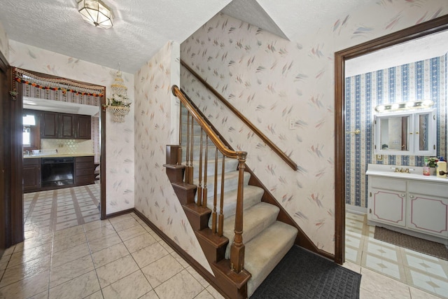 6329 Birkewood St, Columbus, OH 43229 - stairs featuring a textured ceiling, wallpapered walls, and baseboards