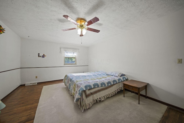 6329 Birkewood St, Columbus, OH 43229 - bedroom featuring wood finished floors, a textured ceiling, a ceiling fan, and baseboards