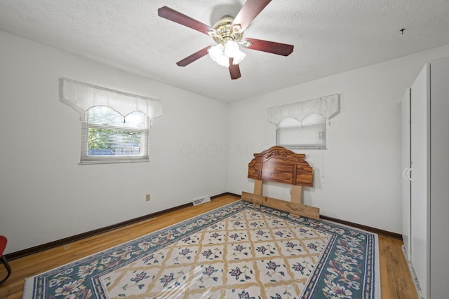 6329 Birkewood St, Columbus, OH 43229 - spare room with wood finished floors, a ceiling fan, a textured ceiling, and baseboards