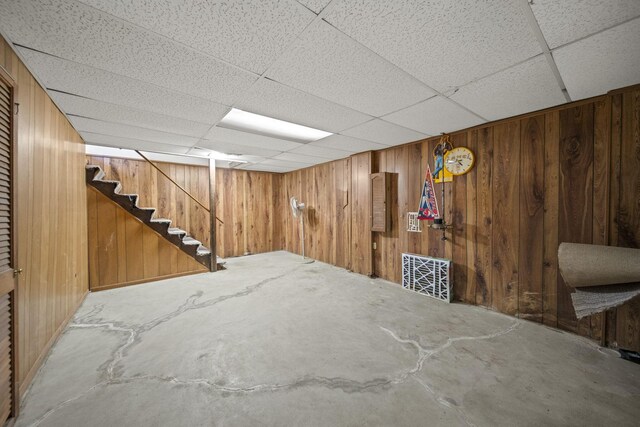6329 Birkewood St, Columbus, OH 43229 - finished basement with wood walls, a drop ceiling, and stairway