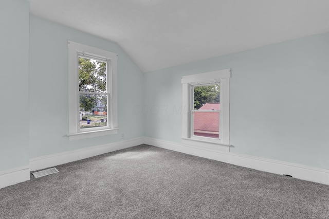 bonus room featuring vaulted ceiling, carpet, and baseboards