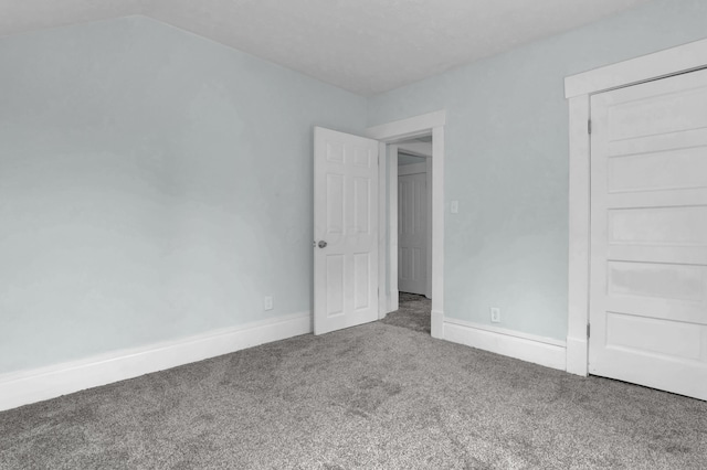unfurnished bedroom with carpet flooring and baseboards