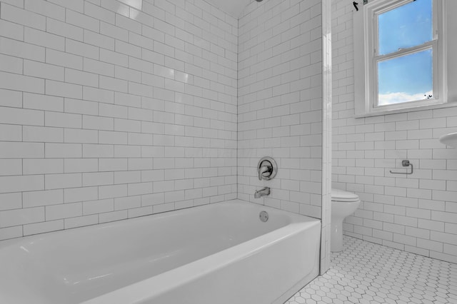 full bath with toilet, a tub to relax in, a shower, and tile walls