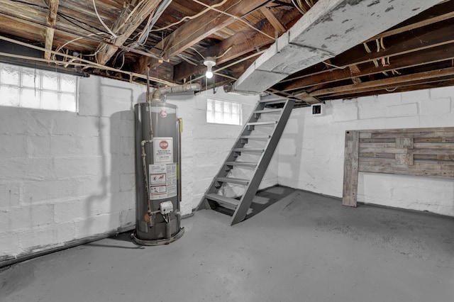 basement featuring gas water heater and stairway