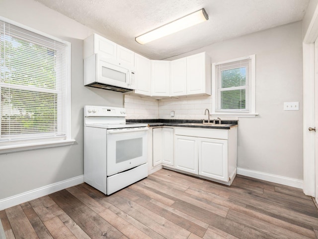 84 Meek Ave, Columbus, OH 43222 - kitchen featuring white appliances, a sink, baseboards, light wood-type flooring, and healthy amount of natural light