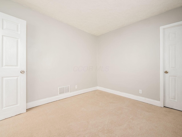 84 Meek Ave, Columbus, OH 43222 - unfurnished room featuring carpet flooring, baseboards, and a textured ceiling