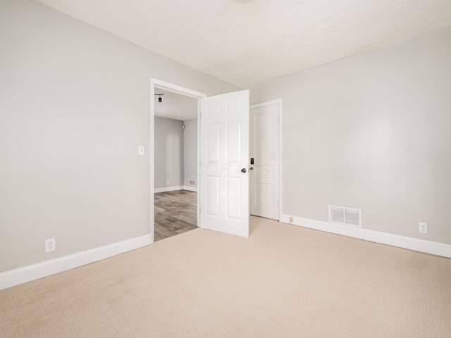 84 Meek Ave, Columbus, OH 43222 - carpeted spare room with baseboards and a textured ceiling
