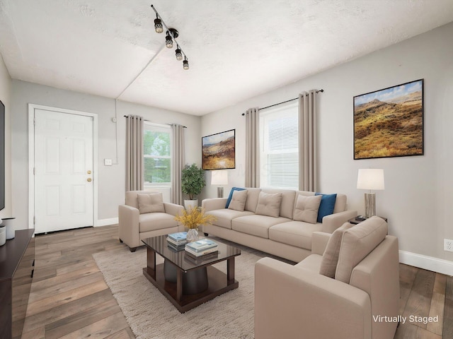 84 Meek Ave, Columbus, OH 43222 - living room featuring baseboards, wood finished floors, rail lighting, and a textured ceiling