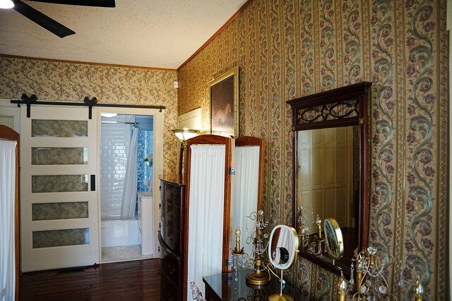 178 W 2nd St, Chillicothe, OH 45601 - hallway with wallpapered walls, hardwood / wood-style flooring, ornamental molding, a barn door, and a textured ceiling