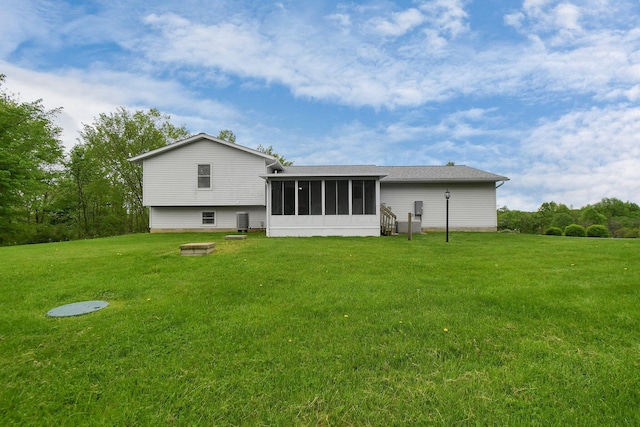 6301 Columbus Rd, Centerburg, OH 43011 - rear view of house with a sunroom and a lawn