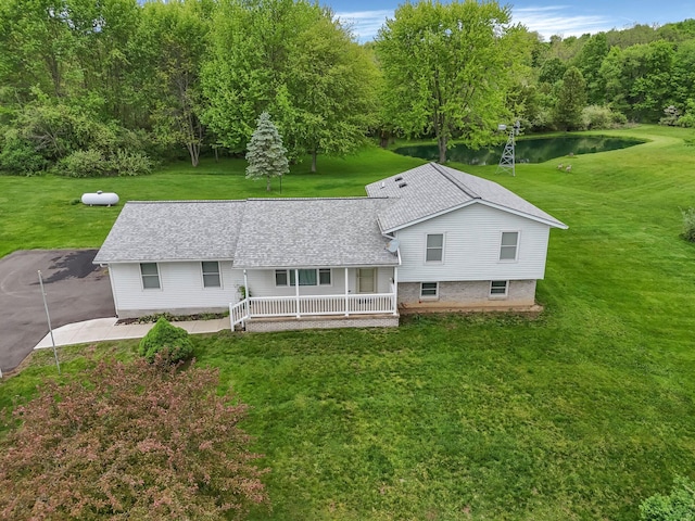 6301 Columbus Rd, Centerburg, OH 43011 - view of front of property featuring covered porch, a water view, a front lawn, and a shingled roof