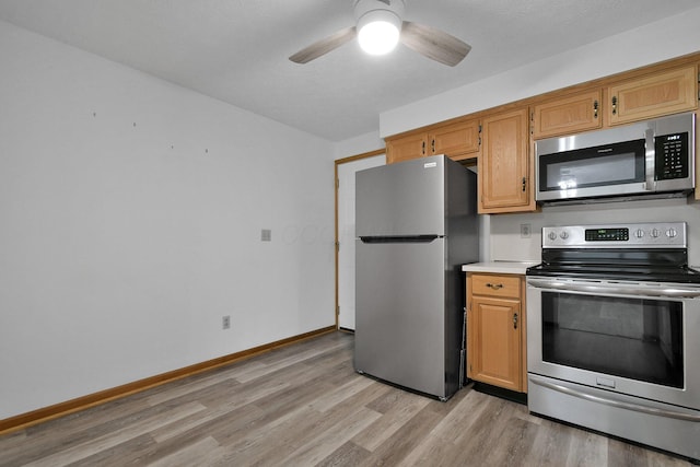 6301 Columbus Rd, Centerburg, OH 43011 - kitchen with stainless steel appliances, light wood finished floors, baseboards, ceiling fan, and light countertops