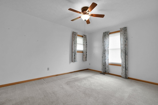 6301 Columbus Rd, Centerburg, OH 43011 - unfurnished room featuring a ceiling fan, light colored carpet, baseboards, and a textured ceiling