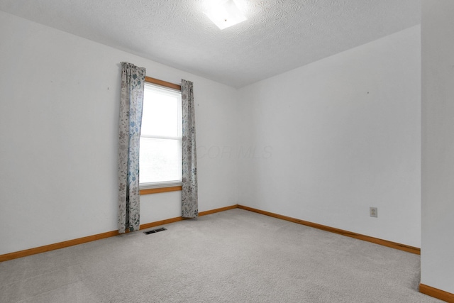 6301 Columbus Rd, Centerburg, OH 43011 - carpeted empty room featuring baseboards and a textured ceiling