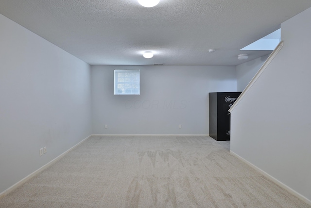 524 Autumn Ridge Cir, Pickerington, OH 43147 - below grade area featuring light carpet, a textured ceiling, and baseboards