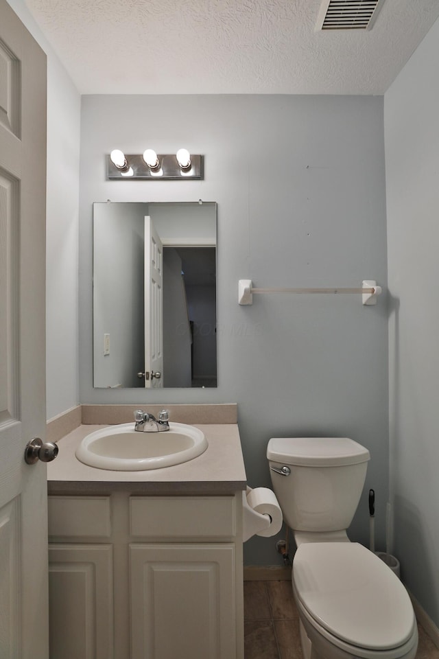 524 Autumn Ridge Cir, Pickerington, OH 43147 - half bath featuring toilet, vanity, baseboards, a textured ceiling, and tile patterned flooring