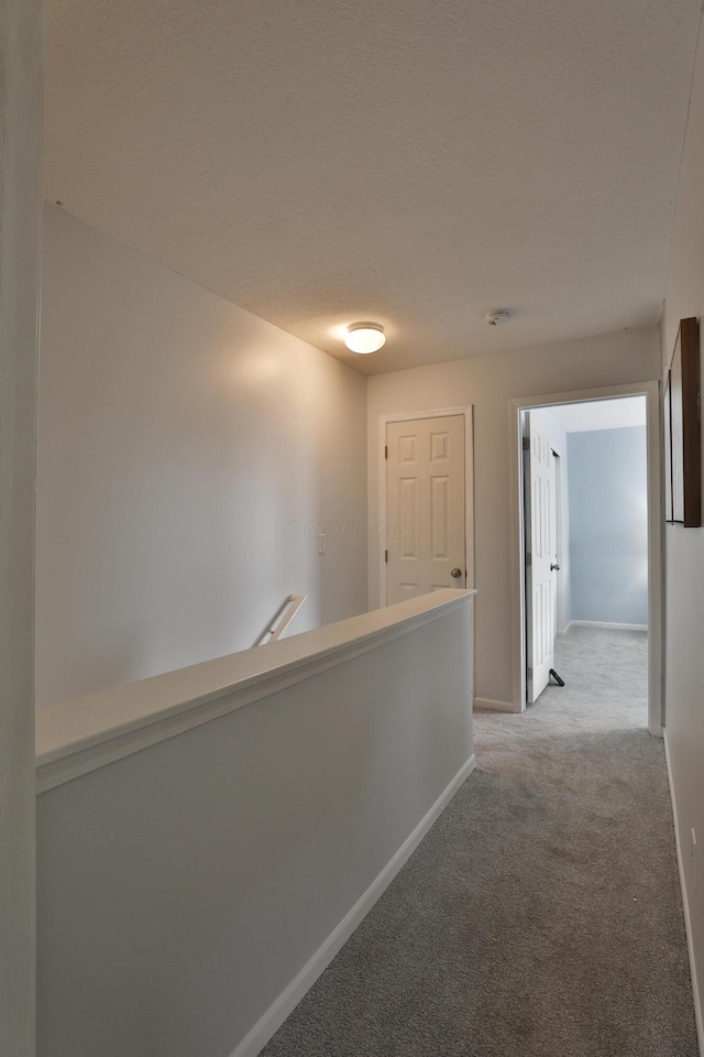 524 Autumn Ridge Cir, Pickerington, OH 43147 - hallway featuring carpet, baseboards, and an upstairs landing