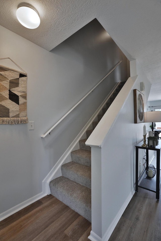 524 Autumn Ridge Cir, Pickerington, OH 43147 - stairs featuring wood finished floors, baseboards, and a textured ceiling