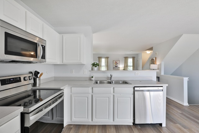 524 Autumn Ridge Cir, Pickerington, OH 43147 - kitchen featuring stainless steel appliances, a sink, a peninsula, white cabinetry, and light countertops