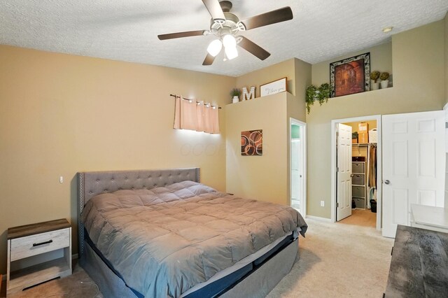 6963 Weurful Dr, Canal Winchester, OH 43110 - bedroom with light carpet, a spacious closet, a textured ceiling, baseboards, and ceiling fan