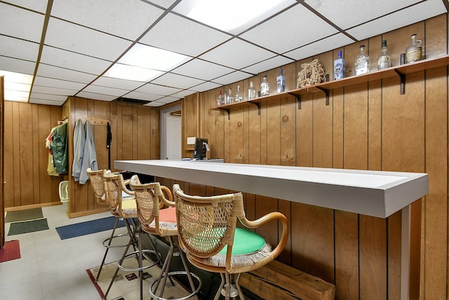 2116 Dunzweiler Dr, Zanesville, OH 43701 - bar area featuring wooden walls, light flooring, and a paneled ceiling