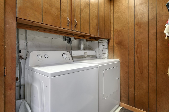 2116 Dunzweiler Dr, Zanesville, OH 43701 - clothes washing area with separate washer and dryer, cabinet space, and wooden walls