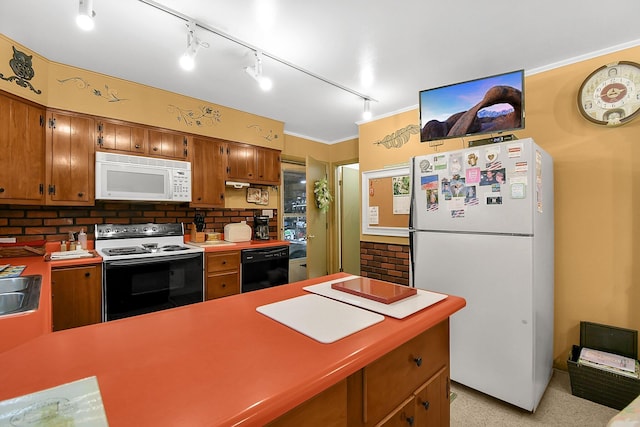 2116 Dunzweiler Dr, Zanesville, OH 43701 - kitchen featuring white appliances, tasteful backsplash, brown cabinetry, and a peninsula
