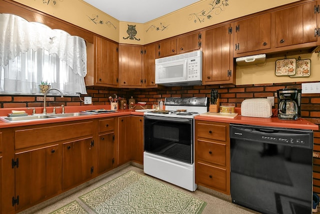 2116 Dunzweiler Dr, Zanesville, OH 43701 - kitchen with white appliances, a sink, brown cabinetry, and light countertops