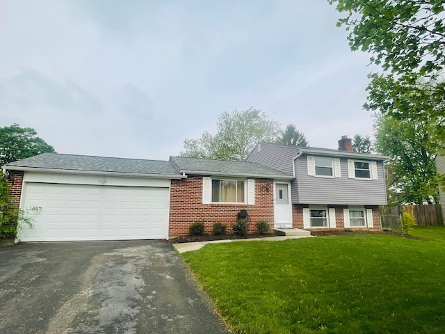 1275 Hathersage Pl, Galloway, OH 43119 - split level home featuring brick siding, asphalt driveway, a garage, a chimney, and roof with shingles