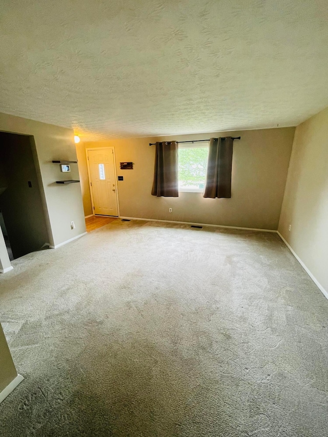 1275 Hathersage Pl, Galloway, OH 43119 - carpeted spare room featuring a textured ceiling and baseboards