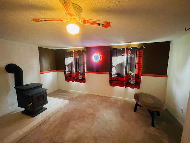 1275 Hathersage Pl, Galloway, OH 43119 - carpeted living area with a wood stove, a textured ceiling, and ceiling fan