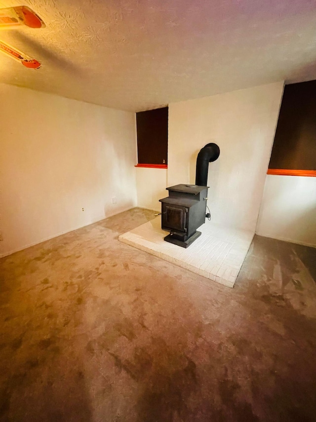 1275 Hathersage Pl, Galloway, OH 43119 - unfurnished living room with a wood stove and carpet