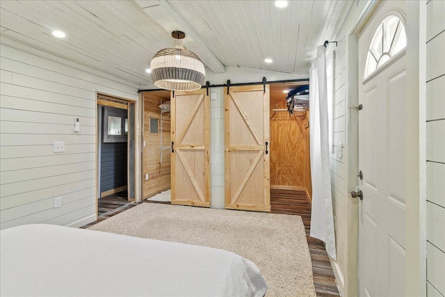 11526 Horseshoe Channel Dr, Lakeview, OH 43331 - bedroom featuring recessed lighting, wood finished floors, wood ceiling, a barn door, and wooden walls