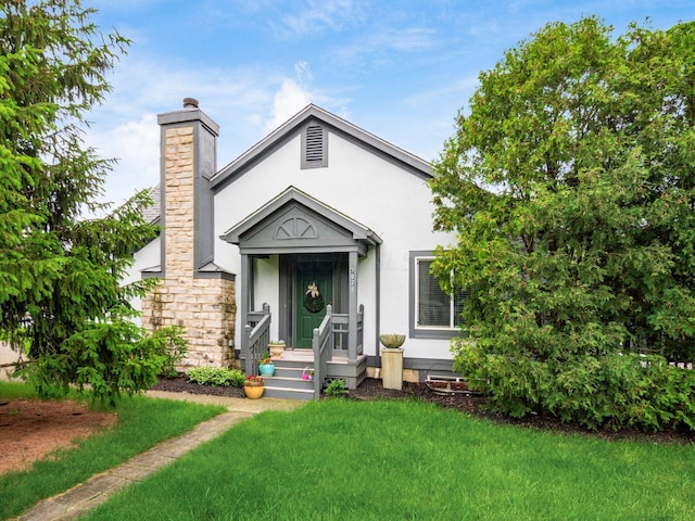 7020 Avery Rd, Dublin, OH 43017 - view of front facade with a chimney, stucco siding, and a front lawn