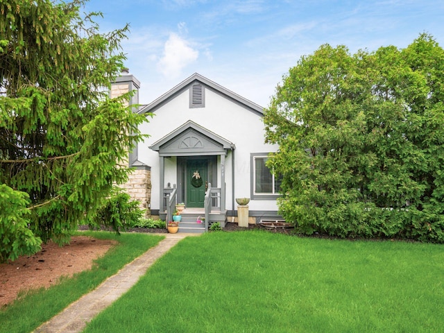 7020 Avery Rd, Dublin, OH 43017 - bungalow-style house featuring a front lawn, a chimney, and stucco siding
