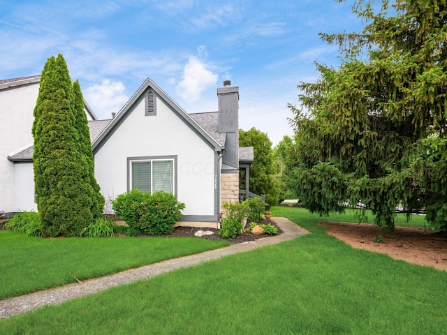 7020 Avery Rd, Dublin, OH 43017 - view of property exterior with stucco siding, a chimney, a yard, and a shingled roof
