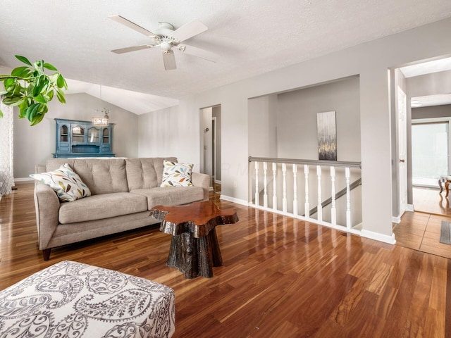 7020 Avery Rd, Dublin, OH 43017 - living area with wood finished floors, a ceiling fan, baseboards, lofted ceiling, and a textured ceiling