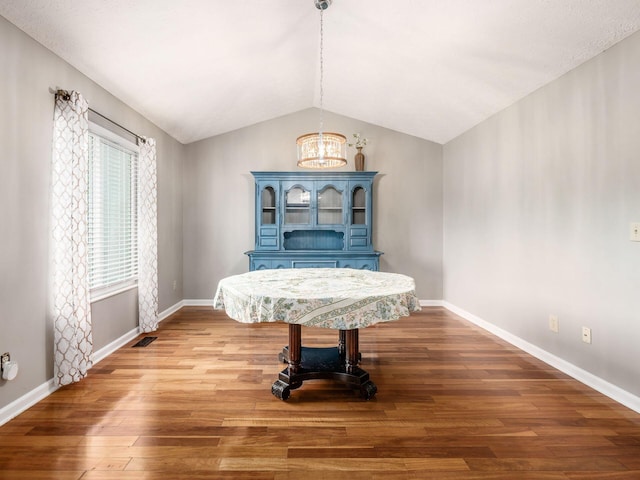 7020 Avery Rd, Dublin, OH 43017 - dining space featuring a chandelier, lofted ceiling, wood finished floors, and baseboards