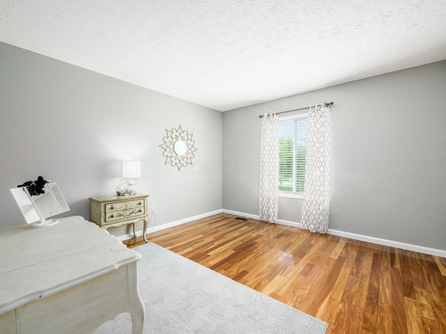 7020 Avery Rd, Dublin, OH 43017 - office with baseboards, wood finished floors, and a textured ceiling