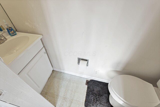 610 W Wheeling St, Lancaster, OH 43130 - half bath with vanity, tile patterned flooring, baseboards, and toilet