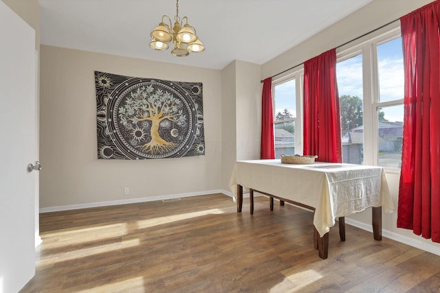 610 W Wheeling St, Lancaster, OH 43130 - dining space with a chandelier, wood finished floors, and baseboards