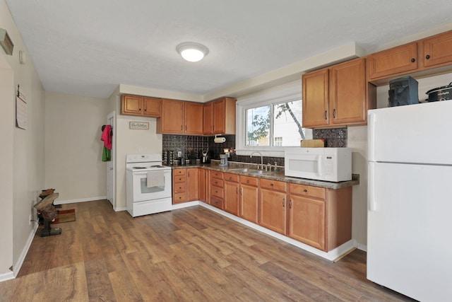 610 W Wheeling St, Lancaster, OH 43130 - kitchen featuring white appliances, a sink, decorative backsplash, and wood finished floors
