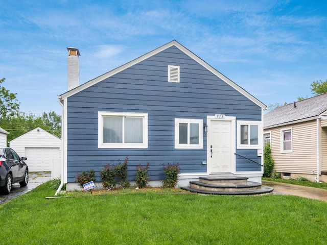 bungalow featuring a chimney, a garage, a front lawn, and an outdoor structure