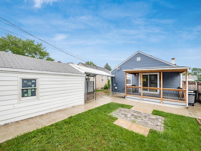 back of property featuring a patio, a lawn, and a chimney