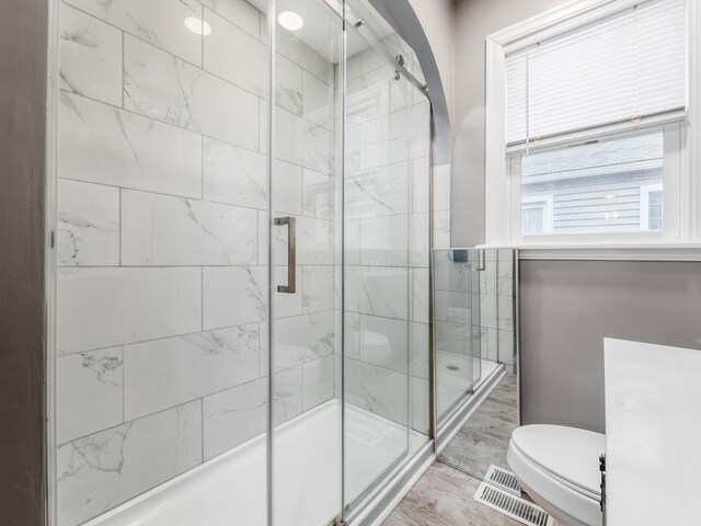 full bath with a shower stall and toilet