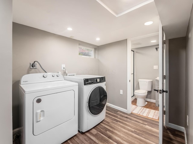 washroom featuring washer and dryer, wood finished floors, baseboards, and recessed lighting